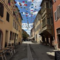 A street with banners hanging between houses