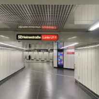 U-bahn station interior, left sign shows exit, right sign shows other platform