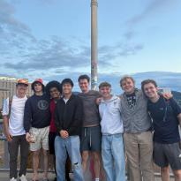 A group of people posing for a picture on a bridge