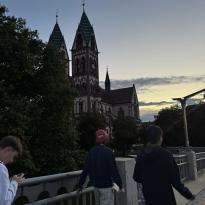 People walking past some buildings