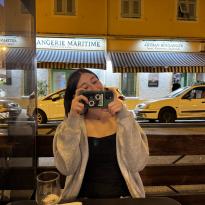 Woman holding up phone to take a photo