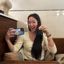 Girl holding up her phone and keychain for a photo