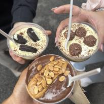Three people holding tiramisu