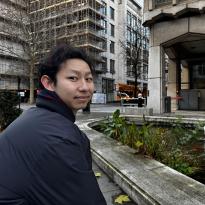 Man posing for a photo with a scenic background