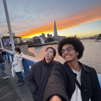 Two people posing with the sunset