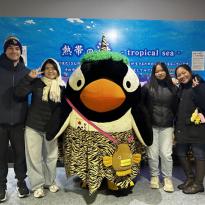 My friend and I posing with the Otaru Aquarium mascot which is a penguin