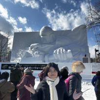 Me posing in front of a huge snow sculpture of the Mandalorian from Star Wars