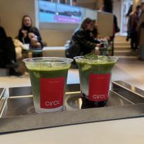 Two sour cherry matcha lattes from Circl Cafe on a aluminum tray