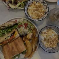 Super Eggplant Sandwich next to two bowls of yogurt with granola from Marmot Cafe.