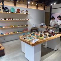 A ceramic shop with many colorful plates and cups.