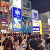 An image full of people crossing the Ebisu Bridge in Osaka.