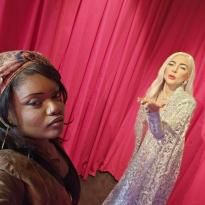 Maxwell to the left of a wax statue resembling lady gaga