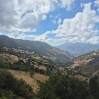 A mountain range with two white towns in the distance