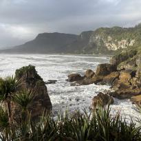 A view of rocks lining the coast of the strong West Coast waves.