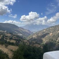Green mountains on either side of the mountain form a valley in the middle