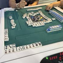 A game of mahjong at a board game cafe.  