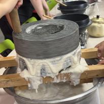 Large stone grinder, grinding soy beans for tofu