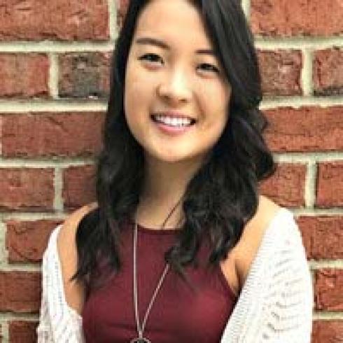 Group posing on a beach with the sea in the background. 

Melted clock draped over a wooden table edge. 

Person with long, wavy hair against a blue background. 

Person smiling in front of a brick wall. This alt text was added with Al; accuracy may vary.