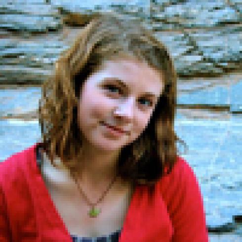 Woman with long brown hair and a neutral expression, outdoors. This alt text was added with Al; accuracy may vary.