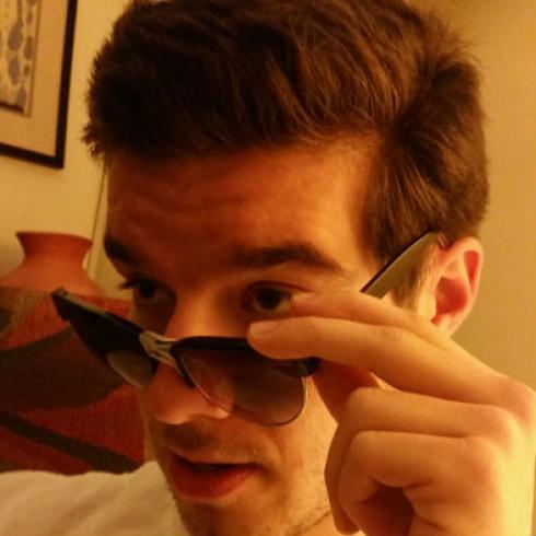 Gray and black patterned viper coiled on a surface. This alt text was added with Al; accuracy may vary.