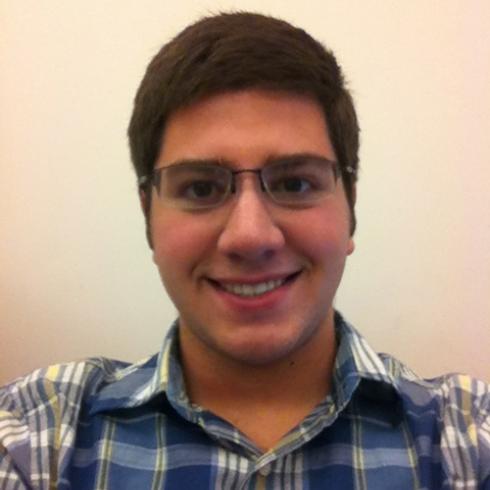 Smiling person with long hair against a white background. This alt text was added with Al; accuracy may vary.