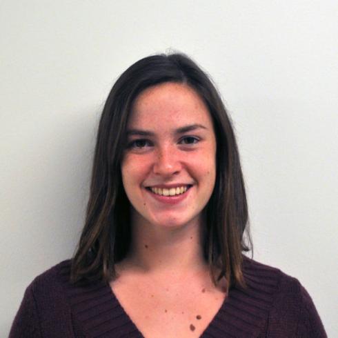 Smiling woman with long hair against a white background. This alt text was added with Al; accuracy may vary.