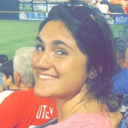 Skyline of a city at dusk with scattered lights and a fading sunset. This alt text was added with Al; accuracy may vary.