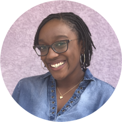 Phoenix Pittman smiling in front of pink background.
