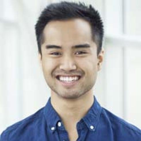 Smiling man in blue shirt, short hair, bright background. This alt text was added with Al; accuracy may vary.
