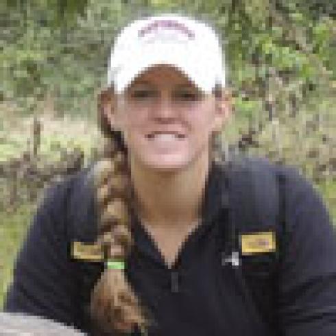 Young man wearing a backward cap, smiling at the camera indoors. This alt text was added with Al; accuracy may vary.