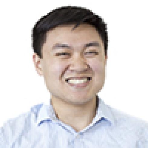 Man smiling in a white shirt against a white background. This alt text was added with Al; accuracy may vary.