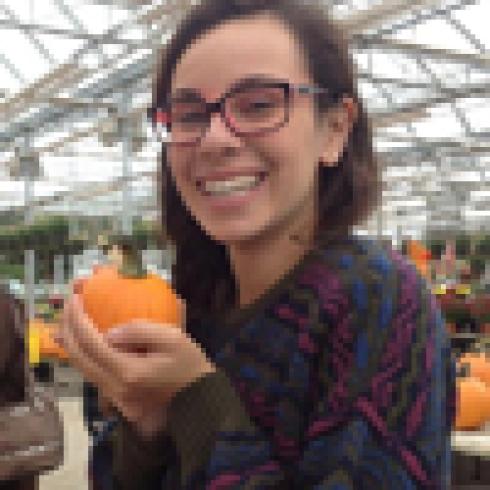 1. Group of five people smiling, standing on a cloudy mountaintop.
2. Reflection of people in sunglasses, taking photos.
3. Smiling person with a bun hairstyle in front of a decorative background.
4. Person wearing glasses with brown hair against a plain background.
5. Smiling person holding a small pumpkin in a greenhouse. This alt text was added with Al; accuracy may vary.