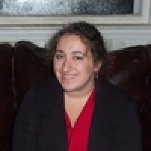 1. Person with glasses and beard wearing a light blue shirt.
2. Woman with long curly hair smiling slightly.
3. Smiling woman with long brown hair, wearing a red top.
4. Woman with shoulder-length hair, smiling, in a white shirt.
5. Woman with curly hair in a black blazer and red shirt. This alt text was added with Al; accuracy may vary.