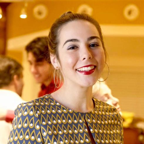 Sunset over city skyline with silhouetted rooftops and warm sky. This alt text was added with Al; accuracy may vary.