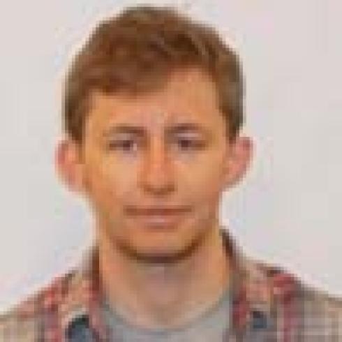 Three people, each wearing glasses or a sweater, smiling outdoors. This alt text was added with Al; accuracy may vary.