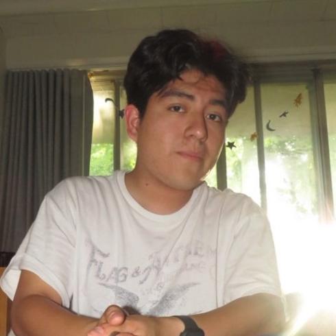 Jonathan Xique Hernandez posing in front of a window.
