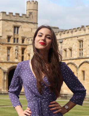 a student poses for a photo in front of Oxford University