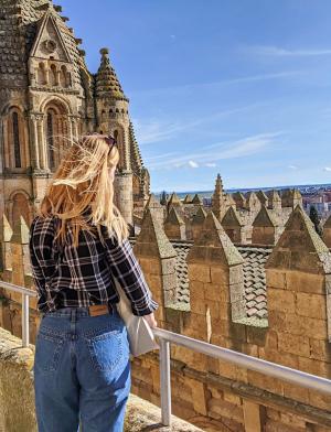 a student looking out over Salamanca from the Old Cathedral