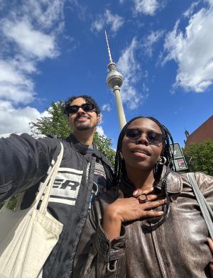 Myles and a friend take a low-angle selfie with the blue sky in berlin.