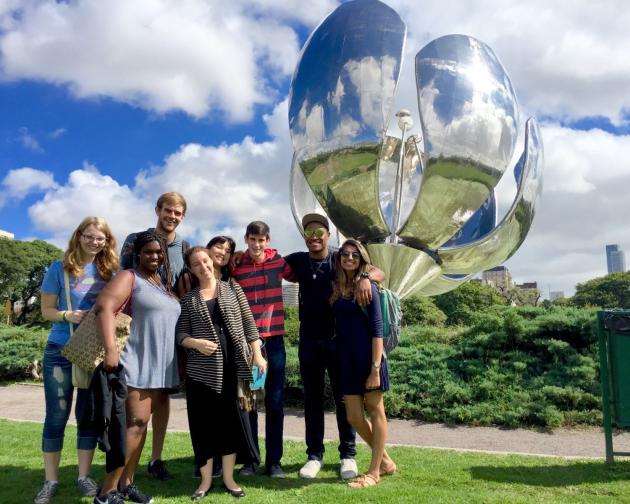 a group of students pose with the Floralis Generica sculpture