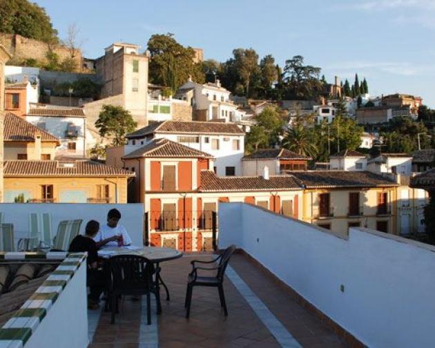 Students sit at a table on the rooftop of the IES Abroad Granada center.