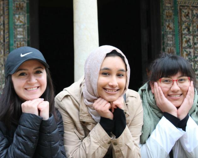 three students smiling for a photo in Rabat