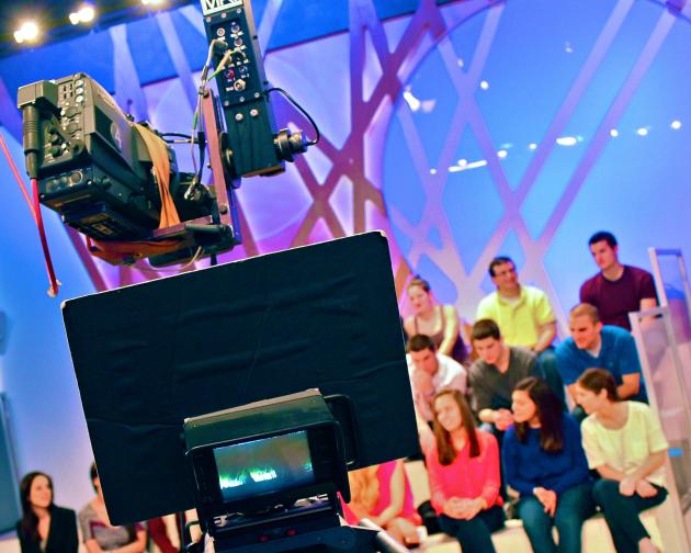 a studio audience behind a camera in Milan
