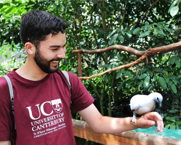 a University of Canterbury student holding a native bird