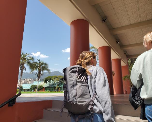 Two students walk outside on the Universidad San Francisco de Quito's campus.