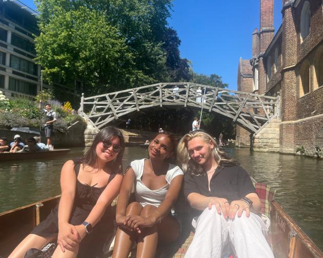 Students on boat by Cambridge mathematical bridge