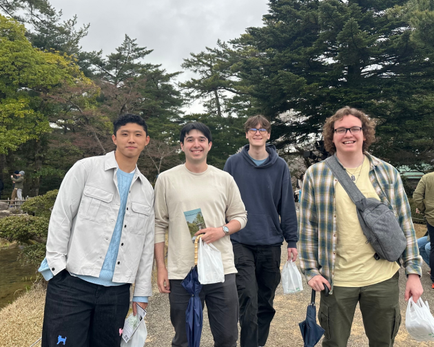 Group of guy students from IES Abroad Tokyo standing in front of trees smiling