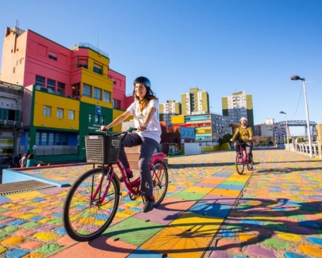 student riding bike in colorful street of Buenos Aires