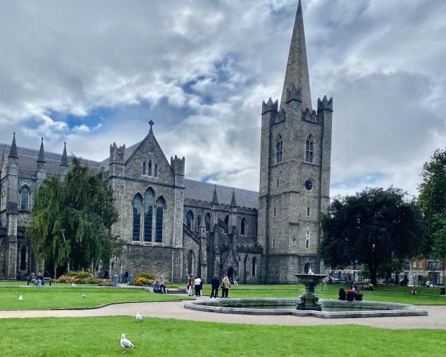 A photo of the fountain and lawn in St. Patrick’s Park with St. Patrick’s Cathedral in the background.