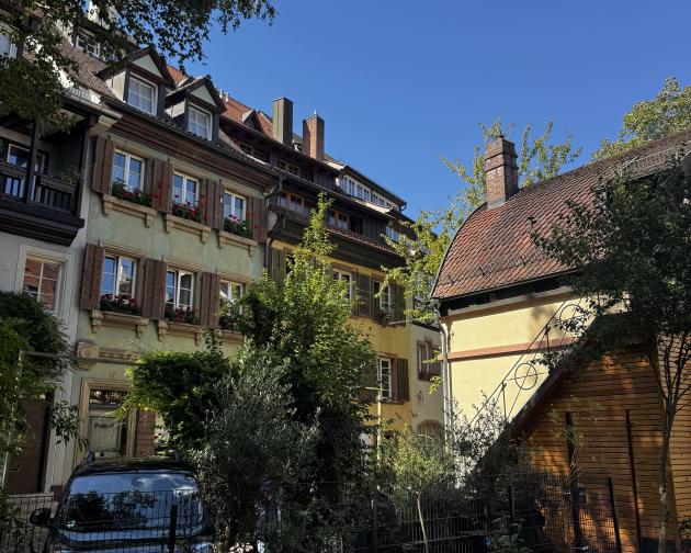 A couple of buildings with some greenery
